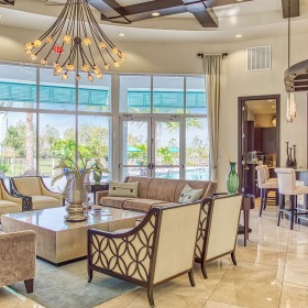 gathering room overlooking pool and including resident bar area and ample seating