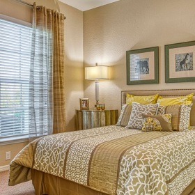 bedroom with a large window allowing natural light and open space around area for a bed