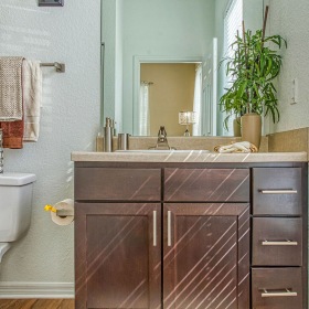 bathroom with minimal and modern cabinetry near toilet and large window