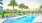 rendering of swimming pool showing tropical landscaping and nearby lakefront