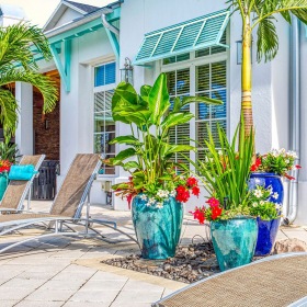 outdoor lounge area with nearby pool cabana and fireplace with ample seating